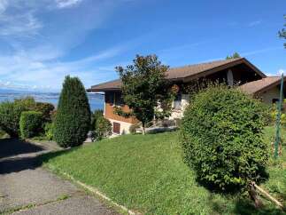 Nestled on a gentle slope with a stunning lake view, this charming property offers a serene retreat.