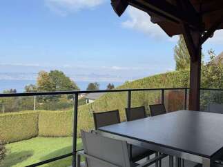 Enjoy breathtaking lake and mountain views from this stunning patio, perfect for al fresco dining or relaxing with a morning coffee.