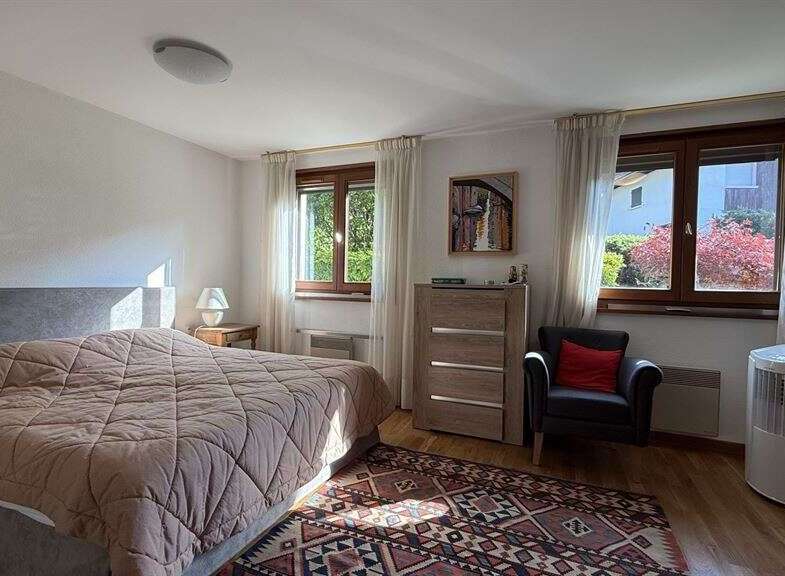 This inviting bedroom features a comfortable bed with a plush comforter, perfect for relaxation.