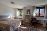 This inviting bedroom features a comfortable bed with a plush comforter, perfect for relaxation.