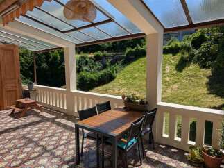 Enjoy outdoor living on this charming patio, complete with a dining set perfect for al fresco meals.