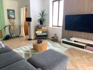 Discover this beautifully designed living room, featuring a modern sectional sofa and a unique, multi-colored dresser that adds a pop of personality.