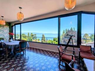 Experience breathtaking lake views from this elegant dining room, featuring a large picture window that floods the space with natural light.