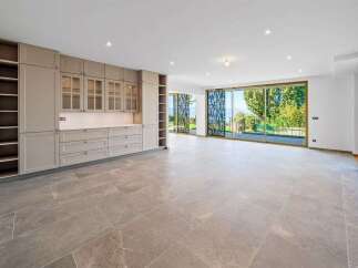 Discover modern living in this spacious, open-plan home featuring a sleek, built-in cabinetry system perfect for storage and display.