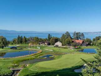 Experience luxury living with this stunning property offering breathtaking views of a serene lake and rolling green hills.