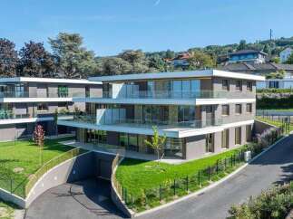 Discover modern luxury living in this stunning multi-story apartment building, featuring sleek architecture and expansive glass balconies offering panoramic views.