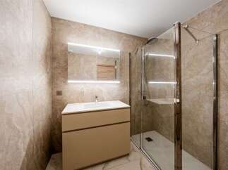 Experience modern luxury in this beautifully appointed bathroom, featuring a sleek vanity with a pristine white countertop and integrated sink.