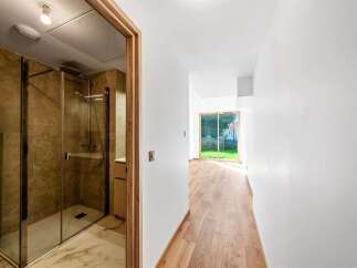 Step into a modern home featuring a sleek, glass-enclosed shower with elegant stone tilework, perfect for a spa-like experience.