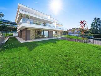 Experience modern luxury in this stunning multi-level residence featuring expansive glass balconies and floor-to-ceiling windows that offer breathtaking views.
