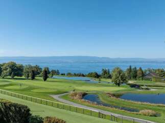 Experience luxury living with breathtaking views of a serene lake and a pristine golf course.