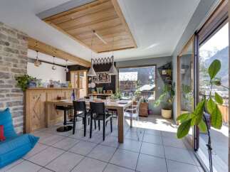 Experience mountain living in this charming dining area, featuring a rustic wooden dining table and chairs perfect for family meals.