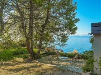 Enjoy breathtaking lake views from this stunning property, featuring a spacious patio perfect for outdoor entertaining.