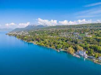 Experience luxury living with this stunning aerial view of a lakeside estate.