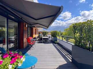 Enjoy breathtaking mountain views from this stunning balcony, perfect for al fresco dining or relaxing with a book.