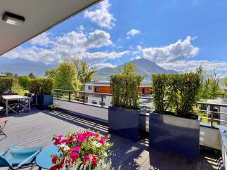 Enjoy breathtaking mountain views from this stunning modern balcony, perfect for outdoor dining and relaxation.
