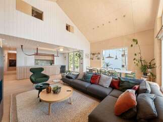 Experience modern living in this stunning open-concept home featuring a vaulted wood-paneled ceiling and abundant natural light.