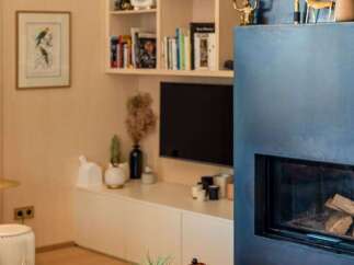 This living room features a modern aesthetic with a striking blue fireplace as the focal point.