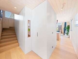 Discover modern living in this beautifully designed home featuring a sleek staircase and a minimalist aesthetic.