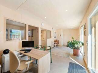 Discover a modern and bright office space featuring a clean aesthetic with light wood paneling throughout.