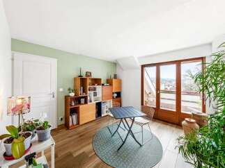 This bright and airy living space features a stylish modular shelving unit, perfect for displaying books and decor.