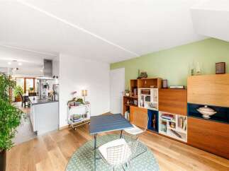 Discover this bright and airy living space, featuring a modern kitchen island and a dining area perfect for intimate meals.