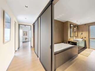 Step into a luxurious bathroom featuring a spacious soaking tub and a double vanity with modern fixtures.