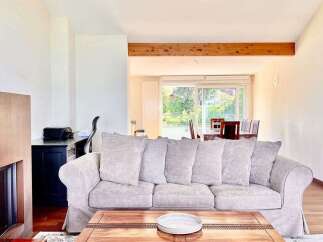 Experience modern living in this spacious apartment, featuring a comfortable living area with a plush sofa and a stylish coffee table.