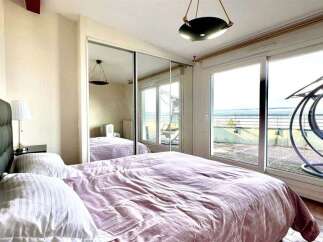 Experience breathtaking sea views from this stunning bedroom, featuring a plush king-sized bed and direct access to a private balcony.