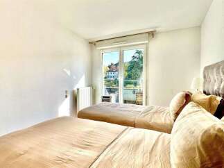 This inviting bedroom features two comfortable beds with plush headboards, perfect for a restful night's sleep.