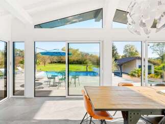 Experience luxurious indoor-outdoor living in this stunning home, featuring expansive glass walls that seamlessly connect to a private backyard oasis.