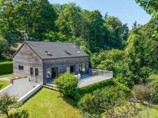 Nestled amidst lush greenery, this charming wooden house offers a serene retreat.