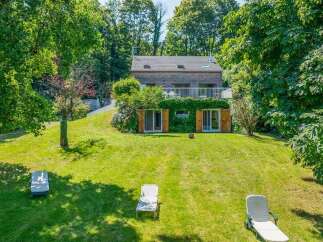 Nestled amidst lush greenery, this charming home offers a serene retreat with ample outdoor space.