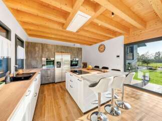 Experience modern living in this stunning kitchen featuring a sleek island with bar seating, perfect for casual dining and entertaining.