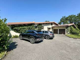 Discover this charming property featuring a spacious driveway leading to a double garage, perfect for car enthusiasts or extra storage.