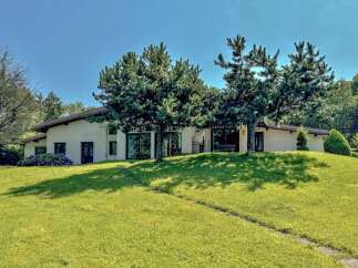 Discover this charming single-family home nestled on a picturesque, sun-drenched hill.