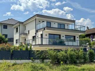 Experience modern living in this stunning multi-story residence featuring sleek architecture and expansive glass balconies.