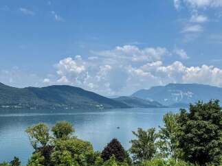Experience breathtaking lakefront living with this stunning property offering panoramic views of the serene waters and majestic mountains.