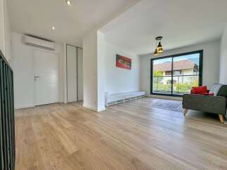 Discover this bright and airy living space featuring a modern aesthetic and ample natural light.