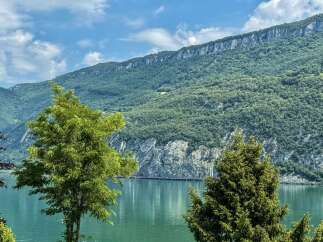 Experience breathtaking natural beauty with this stunning property offering panoramic views of a serene lake and majestic mountains.