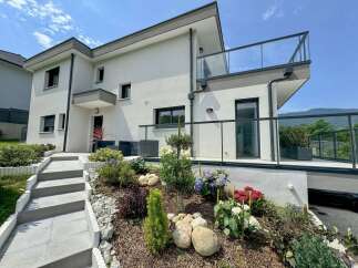 Discover modern living in this stunning multi-story home featuring a sleek white stucco exterior and a contemporary flat roofline.