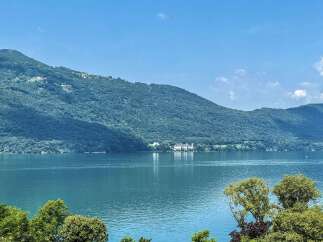Experience breathtaking lakefront living with this stunning property offering panoramic views of the serene waters and lush, tree-covered mountains.