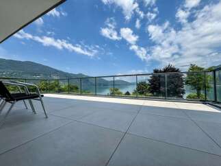 Experience breathtaking lake and mountain views from this stunning modern balcony.