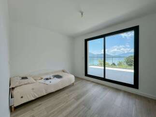 Experience breathtaking lake and mountain views from this modern bedroom, featuring a comfortable single bed with charming celestial-themed bedding.