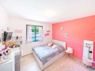 Discover this charming bedroom featuring a comfortable bed with a stylish duvet, perfect for relaxation.