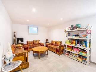 Discover a cozy living space featuring traditional Moroccan-inspired seating arrangements and a unique octagonal coffee table, perfect for intimate gatherings.