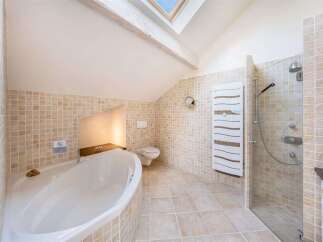 Experience ultimate relaxation in this luxurious bathroom featuring a deep soaking tub and a separate glass-enclosed shower.