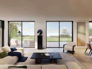 Experience modern luxury in this stunning living space, featuring expansive floor-to-ceiling windows that offer breathtaking ocean views.