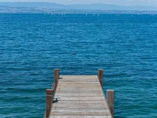 Enjoy serene lakefront living with this charming property featuring a private wooden dock.