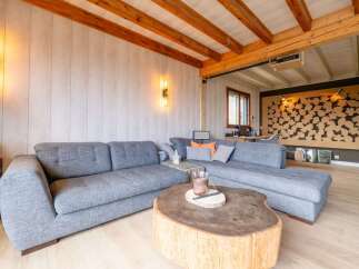 Experience modern living in this stylish living room featuring a spacious sectional sofa and a unique live-edge coffee table.