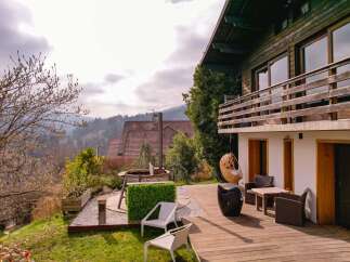 Experience serene living with this stunning property featuring a spacious wooden deck perfect for outdoor entertaining.